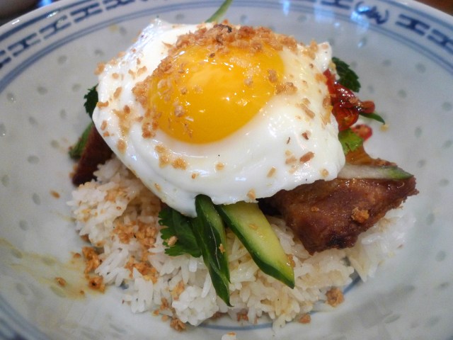 Crispy Pork Belly on steamed rice with chili caramel, mint and fried egg