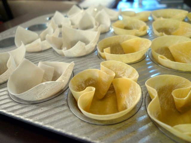 gently press the wonton wrappers into the mini-muffin tin