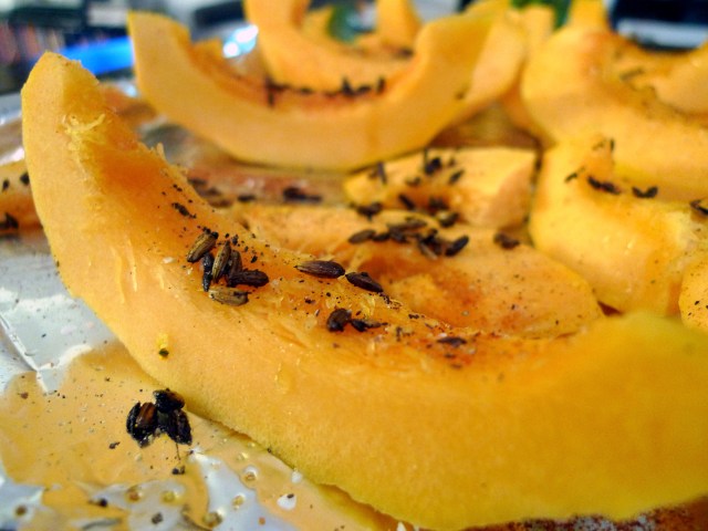 pour tempered spices over squash