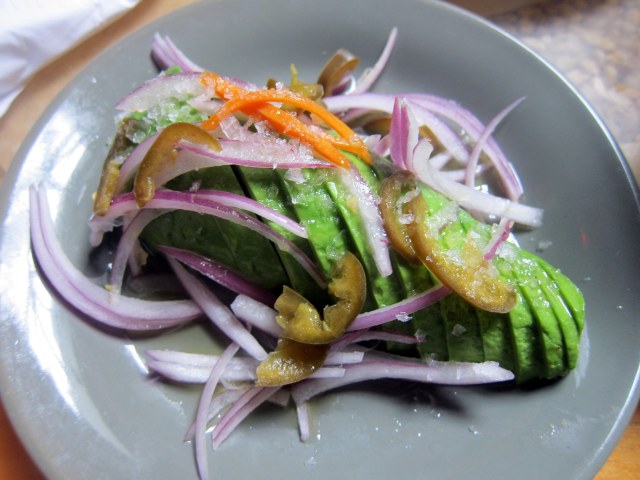 Avocado with red onions, chile peppers and salt