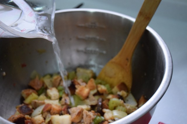 pour in broth to moisten the bread cubes